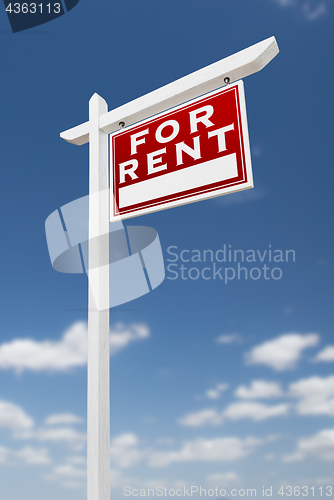 Image of Right Facing For Rent Real Estate Sign on a Blue Sky with Clouds