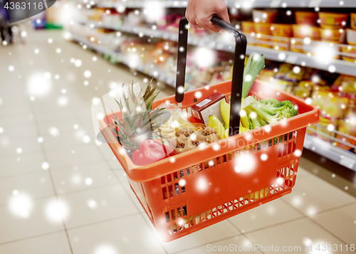 Image of woman with food basket at grocery or supermarket