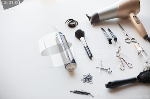 Image of hairdryer, scissors and other hair styling tools