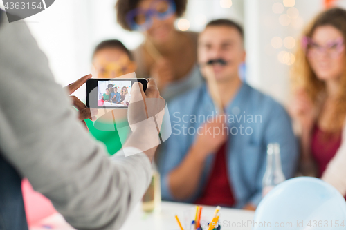 Image of friends or coworkers photographing at office party