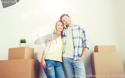 Image of smiling couple with big boxes moving to new home