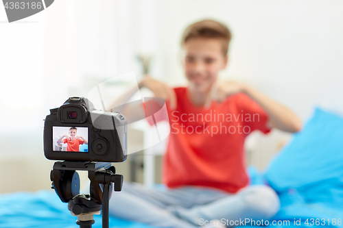 Image of camera recording video of blogger boy at home