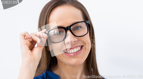 Image of close up of smiling middle aged woman in glasses