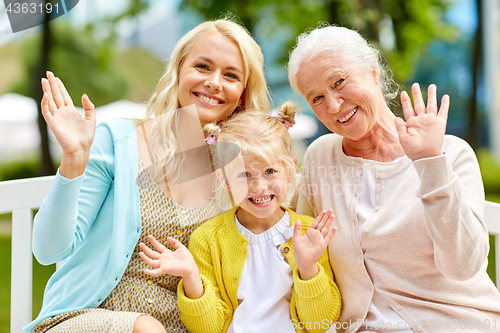 Image of woman with daughter and senior mother at park