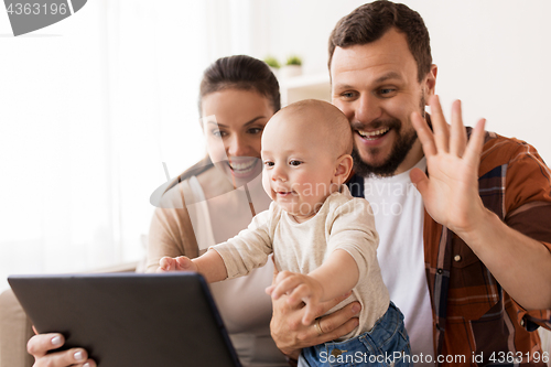 Image of mother, father and baby with tablet pc at home
