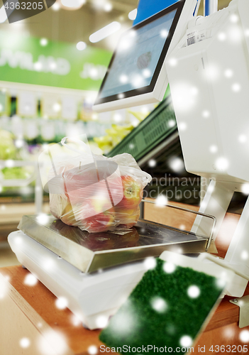 Image of apples in plastic bag on scale at grocery store