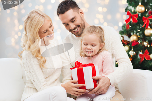 Image of happy family with christmas gift