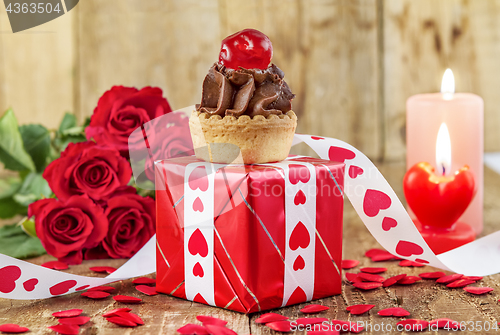 Image of Cupcake with cherry over red gift box