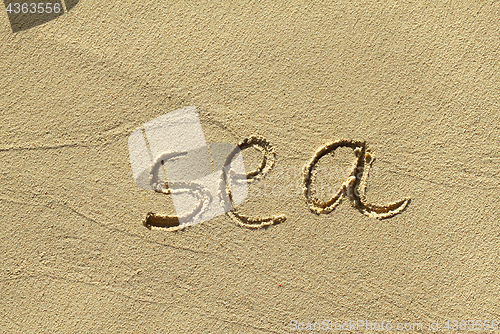 Image of Natural sand background with scrawled word ''Sea''