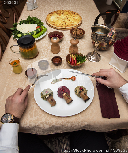 Image of Man eating in georgian restaurant