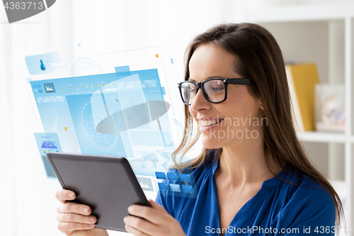 Image of woman with tablet pc working at home or office