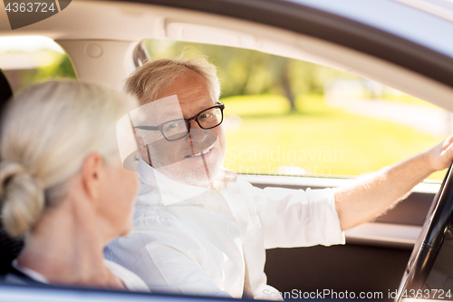 Image of happy senior couple driving in car