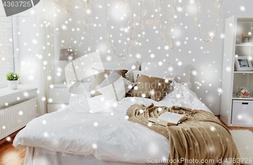 Image of bedroom with bed and christmas garland at home