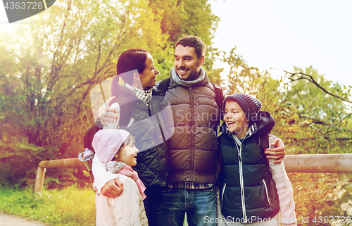 Image of happy family with backpacks hiking