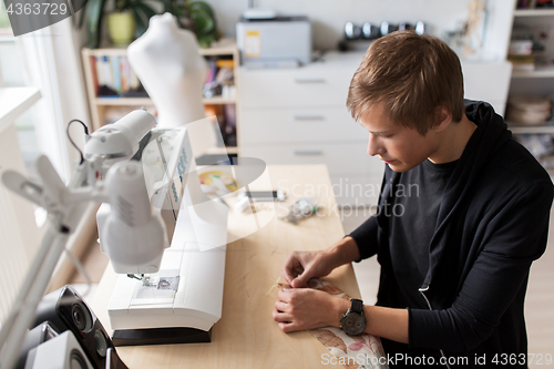 Image of fashion designer with making dress at studio