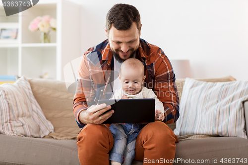 Image of happy father and baby boy with tablet pc at home