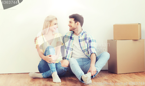 Image of couple with cardboard boxes moving to new home