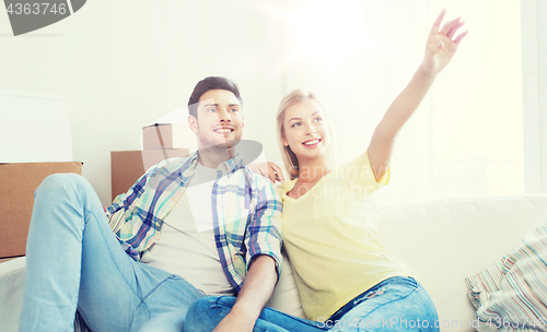 Image of couple with boxes moving to new home and dreaming