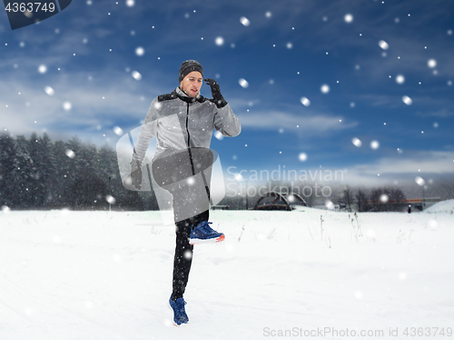 Image of man exercising and warmig up in winter outdoors