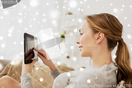 Image of smiling woman with tablet pc at home