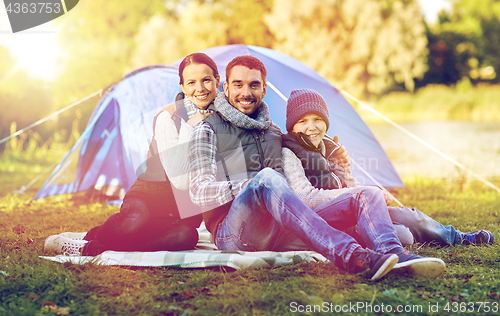 Image of happy family with tent at camp site