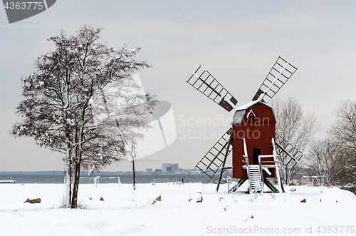 Image of Old windmill in a winter scenery