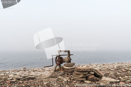 Image of Old boat winch by the coast