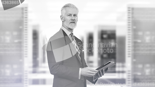 Image of Senior businessman in server room