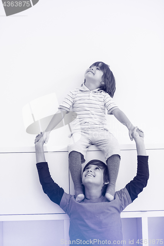 Image of young boys posing line up piggyback