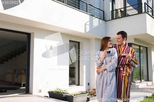 Image of Young beautiful couple in bathrobes