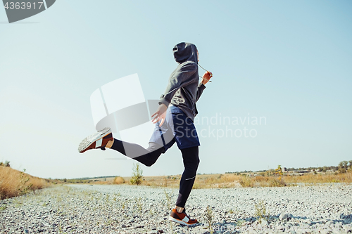 Image of Running sport. Man runner sprinting outdoor in scenic nature. Fit muscular male athlete training trail running for marathon run.