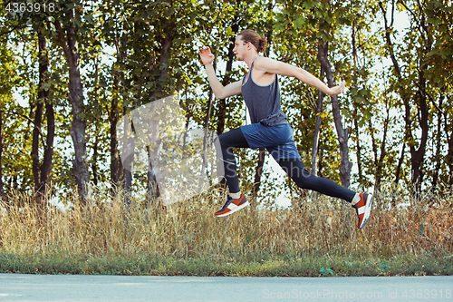 Image of Running sport. Man runner sprinting outdoor in scenic nature. Fit muscular male athlete training trail running for marathon run.