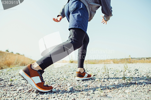 Image of Running sport. Man runner sprinting outdoor in scenic nature. Fit muscular male athlete training trail running for marathon run.