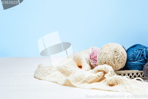 Image of The balls of wool on white wooden background