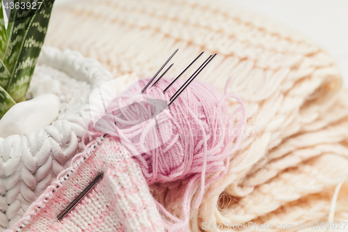 Image of The balls of wool on white wooden background