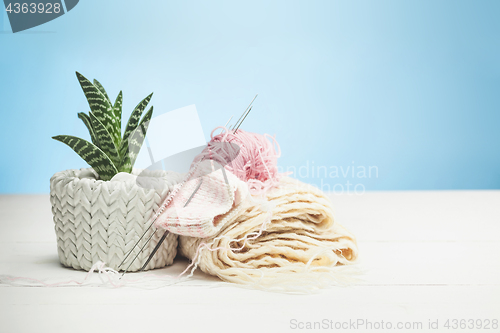 Image of The balls of wool on white wooden background