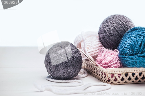 Image of The balls of wool on white wooden background