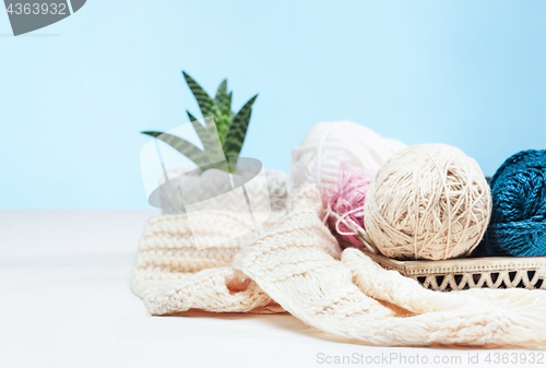 Image of The balls of wool on white wooden background