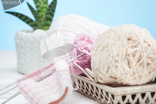 Image of The balls of wool on white wooden background