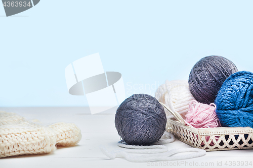 Image of The balls of wool on white wooden background