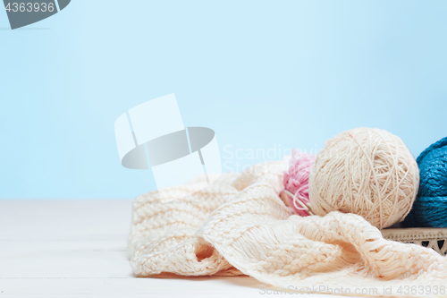 Image of The balls of wool on white wooden background