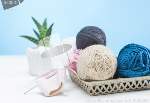 Image of The balls of wool on white wooden background