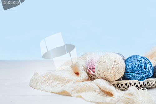 Image of The balls of wool on white wooden background