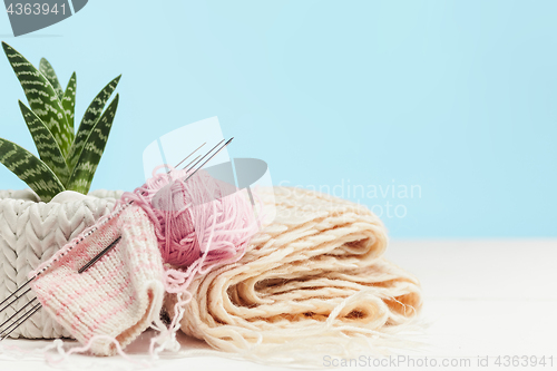 Image of The balls of wool on white wooden background