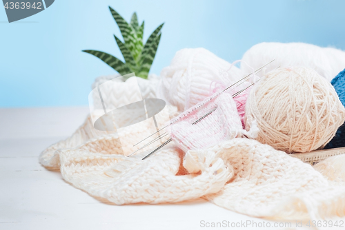 Image of The balls of wool on white wooden background