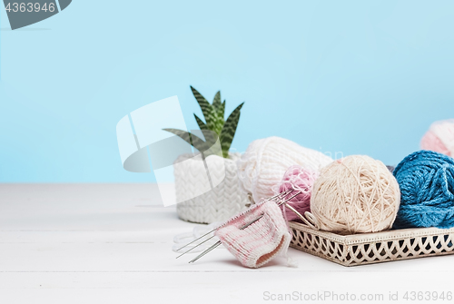 Image of The balls of wool on white wooden background