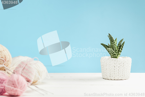 Image of The balls of wool on white wooden background