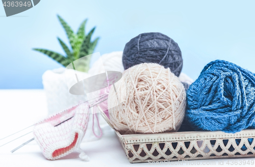 Image of The balls of wool on white wooden background