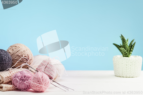 Image of The balls of wool on white wooden background