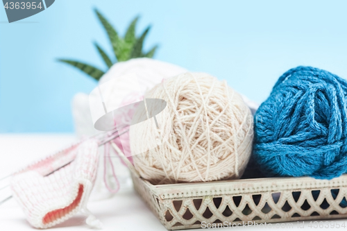 Image of The balls of wool on white wooden background